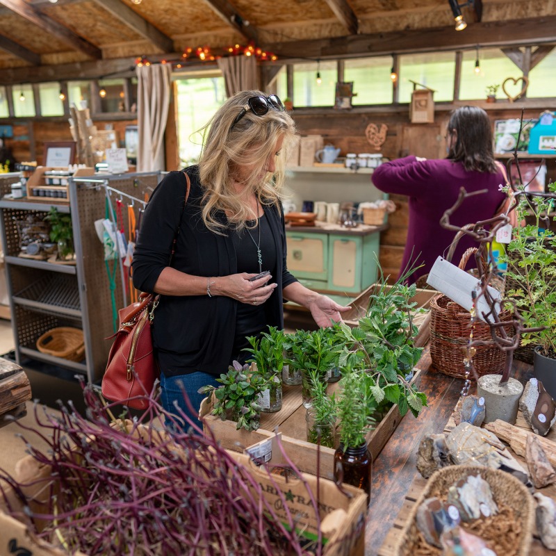 Lilliputopia, Monroe, Oregon - A woman browses goods inside Lilliputopia's farmstore.