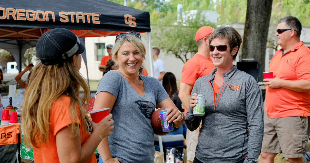 Oregon State University, Corvallis, Oregon - Three women enjoy drinks while tailgating at OSU
