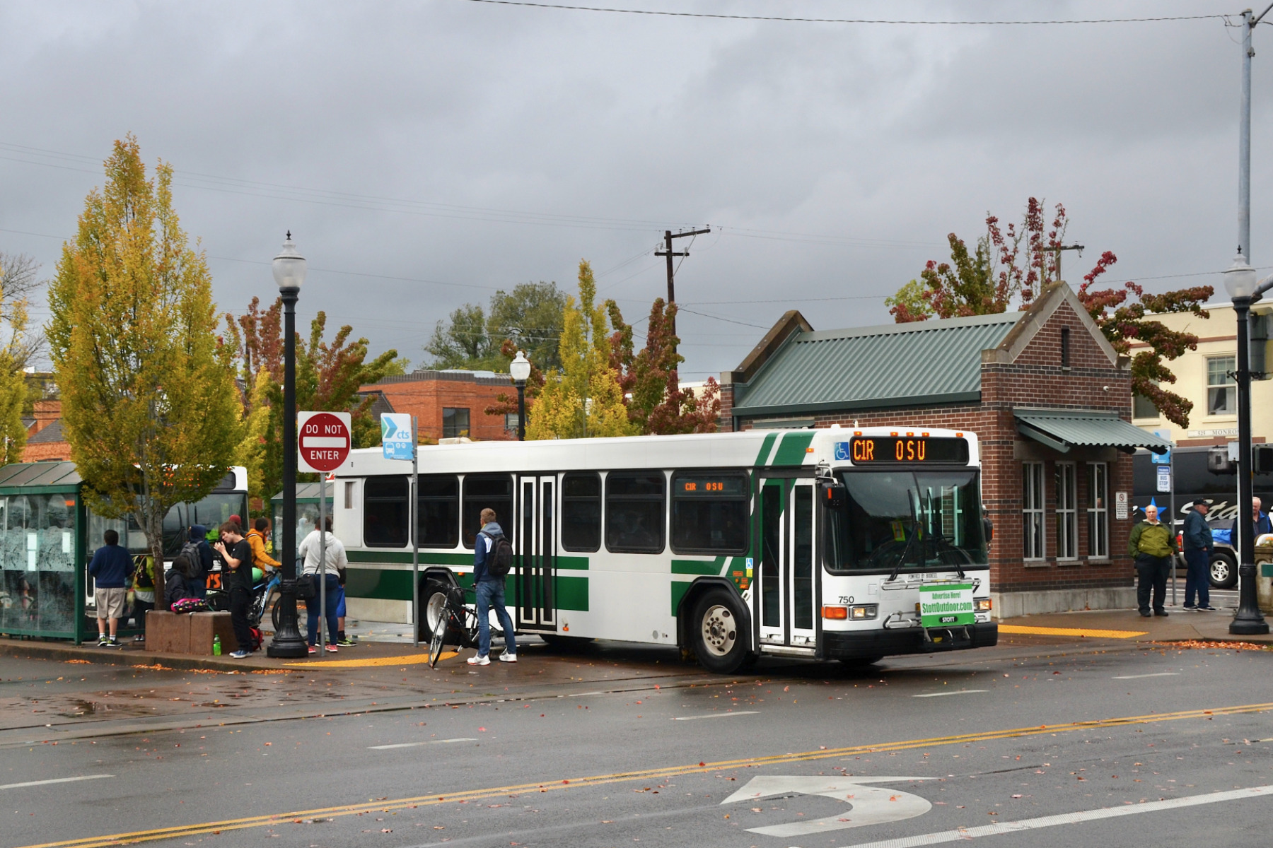 Corvallis Transit System bus 750, a 35-foot, low-floor diesel bus built in 2009 by Gillig, pulling out of the Downtown Transit Center, onto 5th Street, bound for Oregon State University on route C1R.