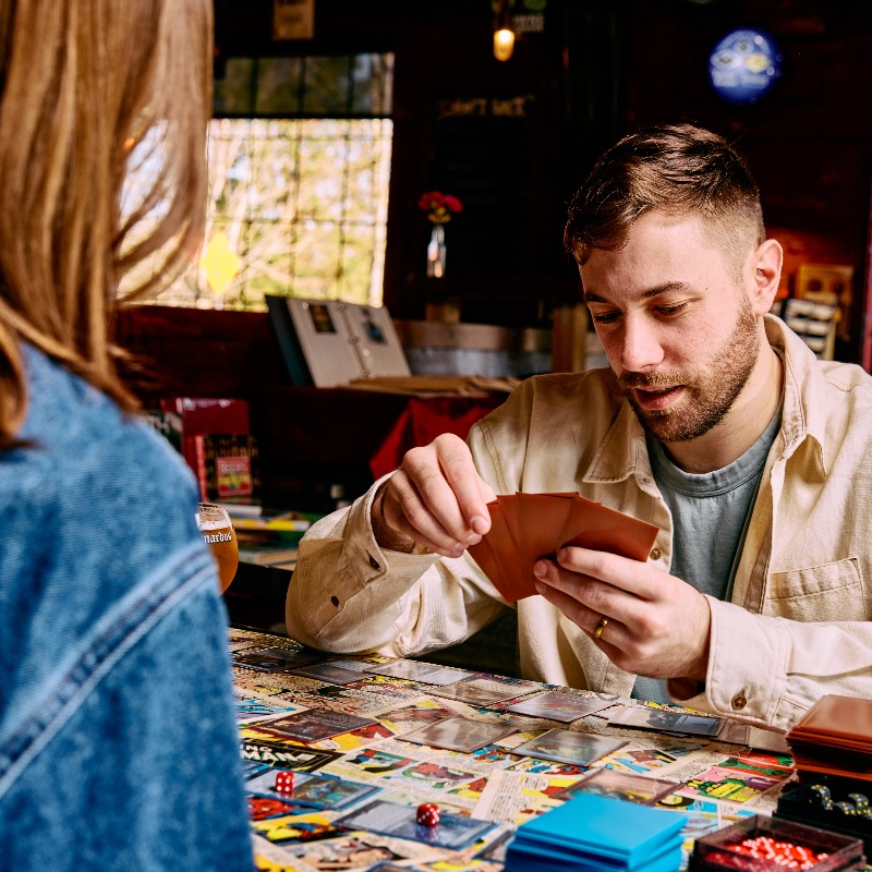 The Biere Library, Corvallis, Oregon - Couple playing Magic: The Gathering at a table in the Biere Library